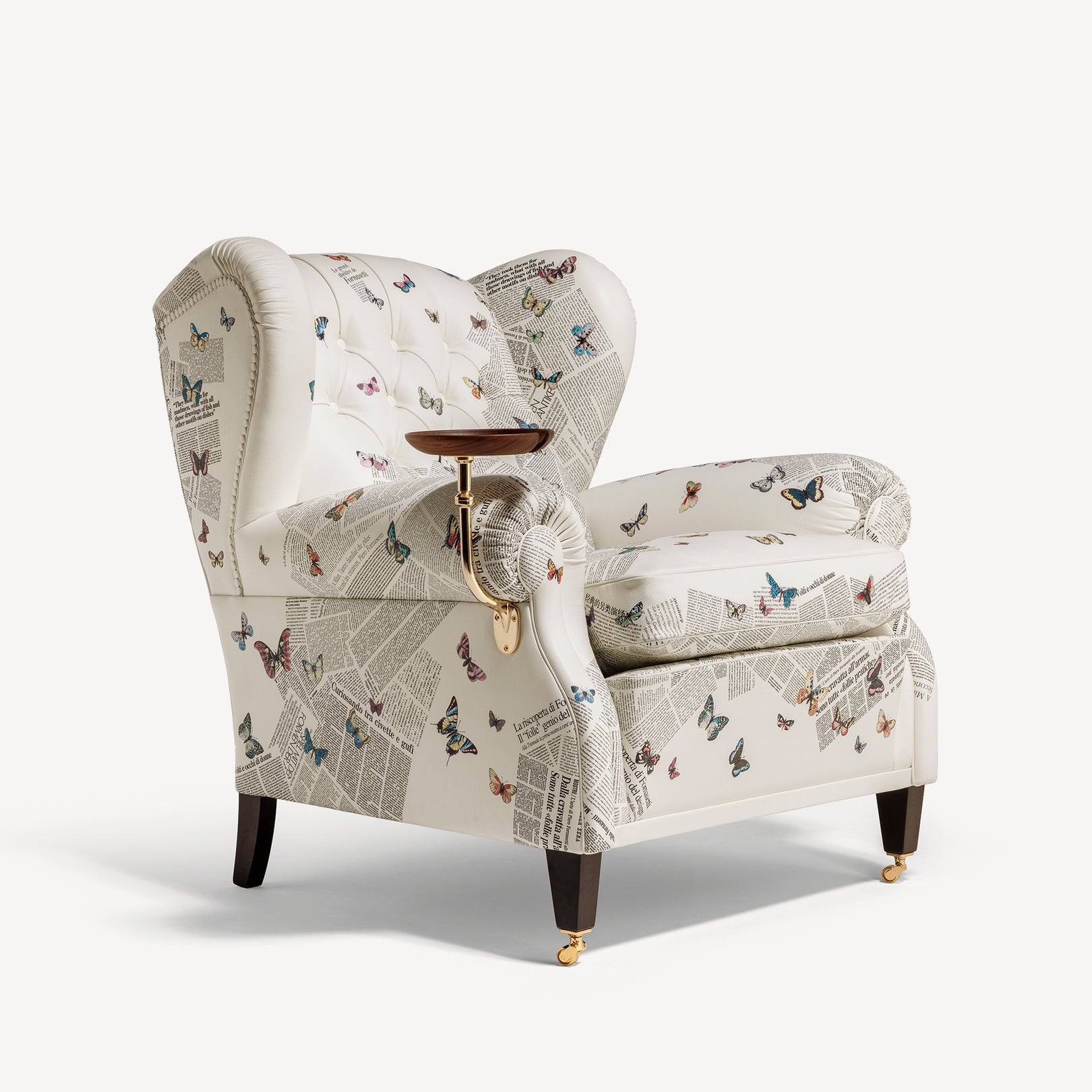 Side view of butterfly-print armchair with tray on left arm