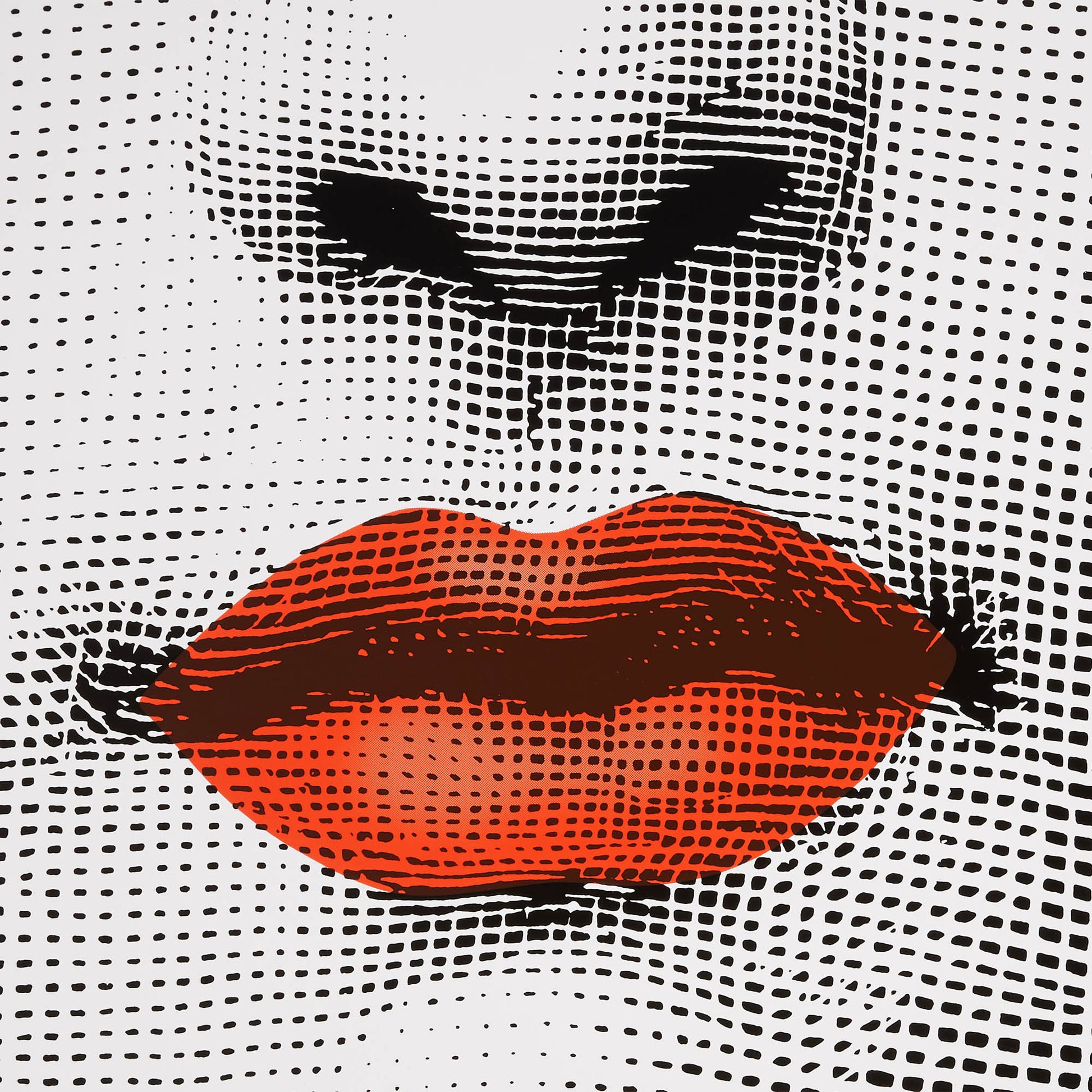 Close-up of red lips printed on round perforated table surface